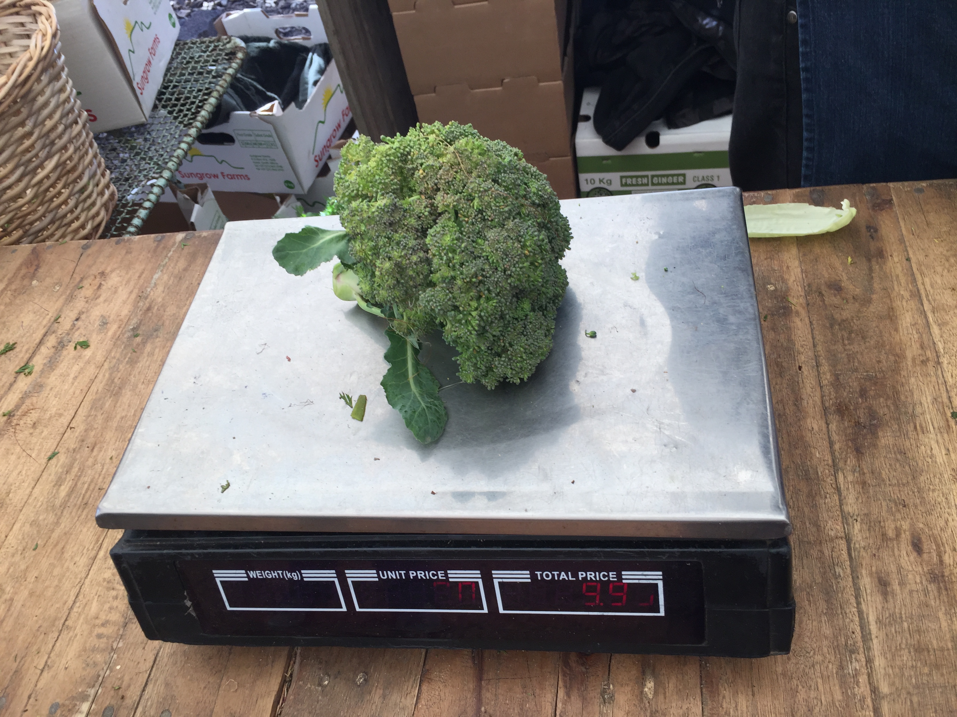 weighing organic broccoli on electric scales at the Granger Bay Market, Cape Town, South Africa - Copyright Great Health Naturally